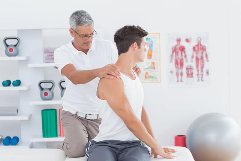 Chiropractor Examining A Patients Range Of Motion