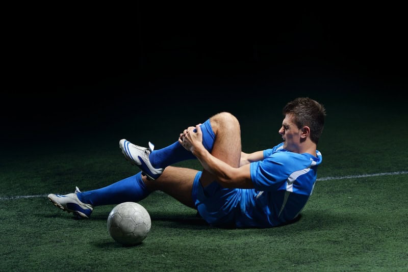 Injured Soccer Playing Holding Leg