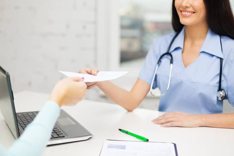 Doctor Handing Patient A Medical Referral