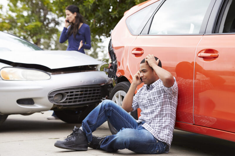 Man on the ground after car accident