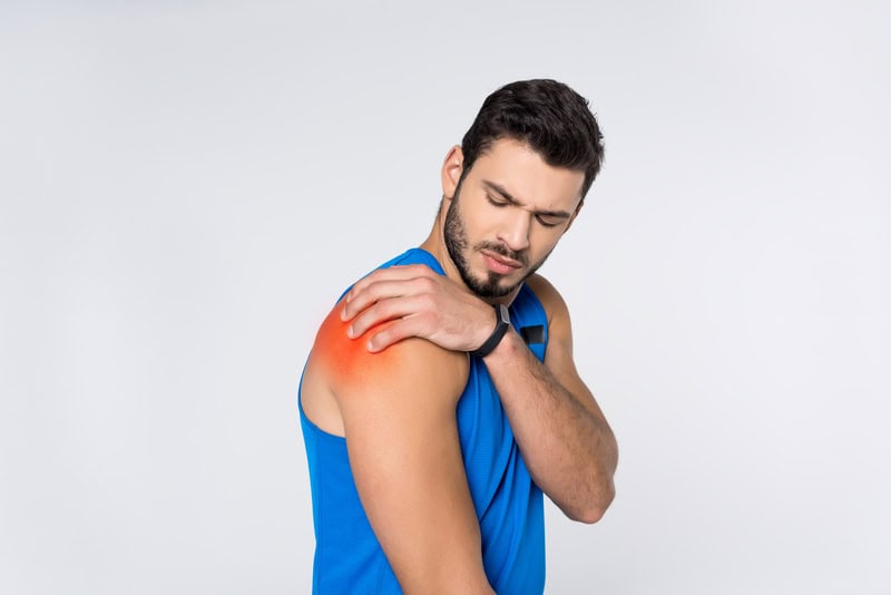 Man Holding Shoulder Due To Shoulder Pain