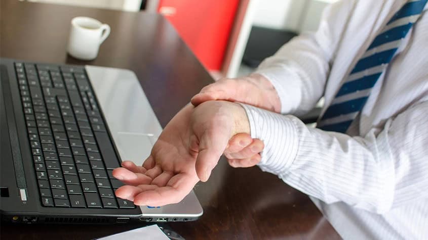 Hands resting from typing on keyboard