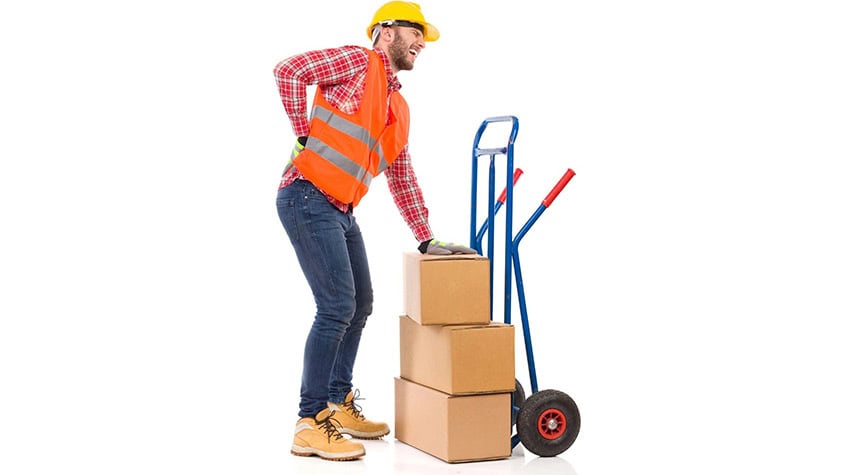 Warehouse employee struggling with back pain while handling a hand truck.